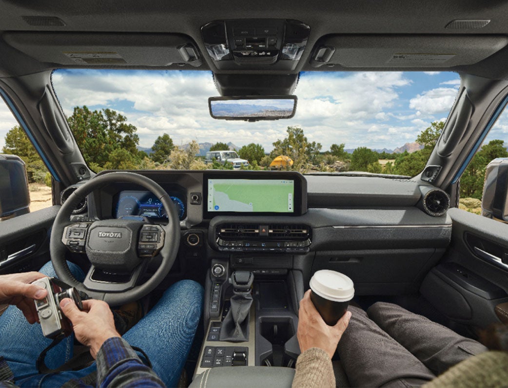 Land Cruiser interior with couple relaxing drinking coffee