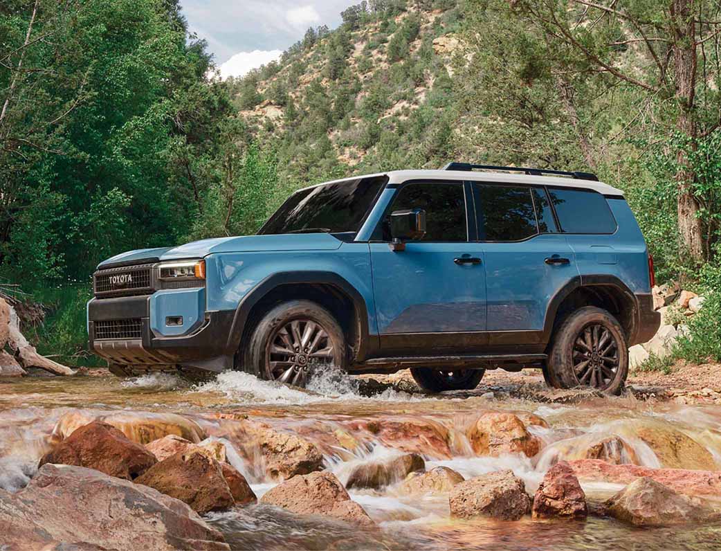 Land Cruiser parked in a park setting on rough terrain