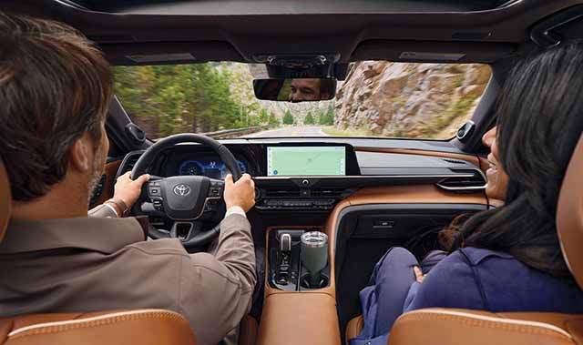 Couple driving comfortably down the road