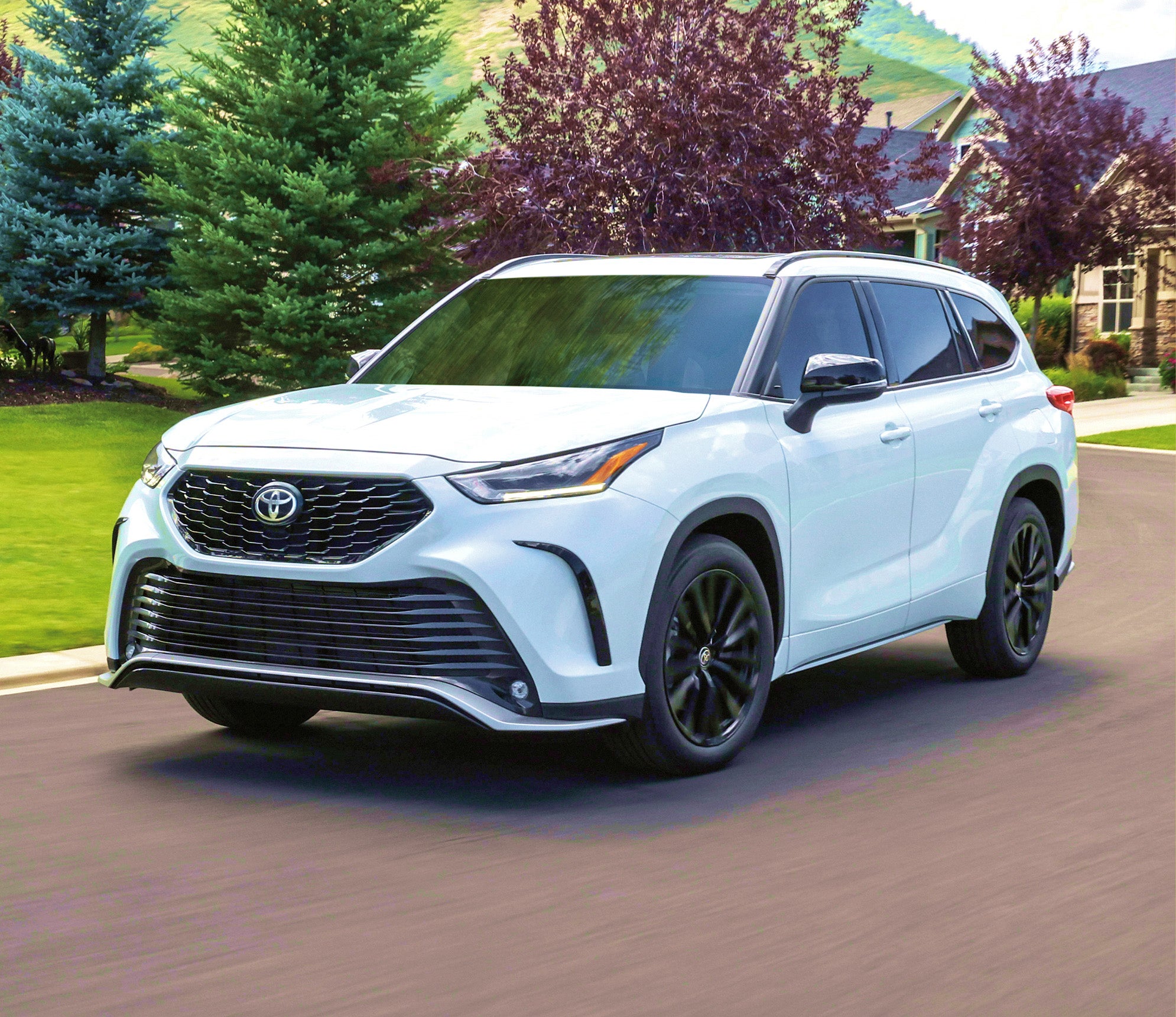 2024 Toyota Highlander driving in a subdivision