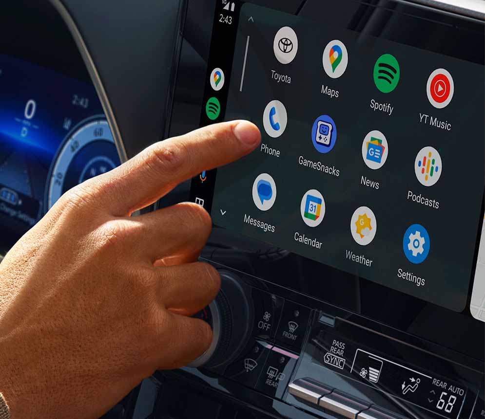 Large infotainment center screen with person about to use the intergrated phone app