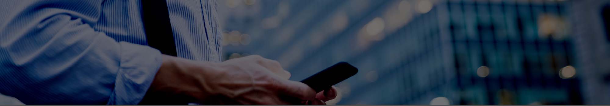 business man texting in a city environment