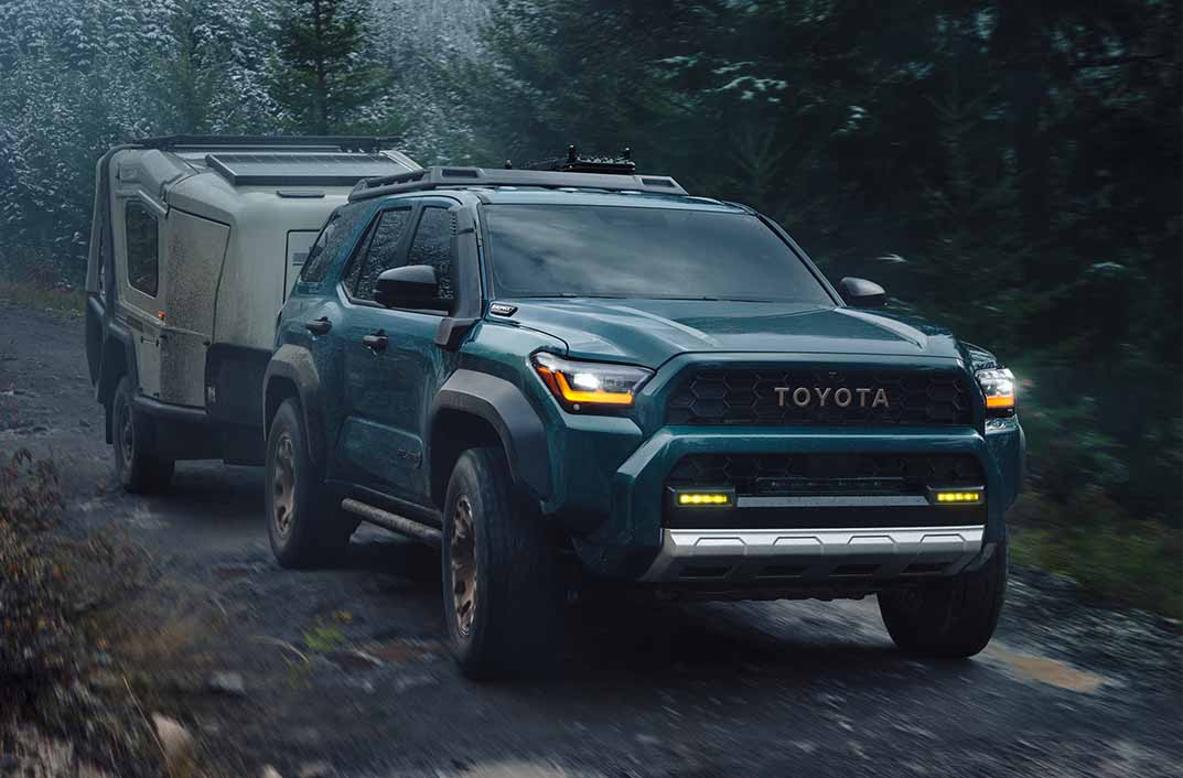 Toyota 4Runner traveling down a dirt road hauling a camper