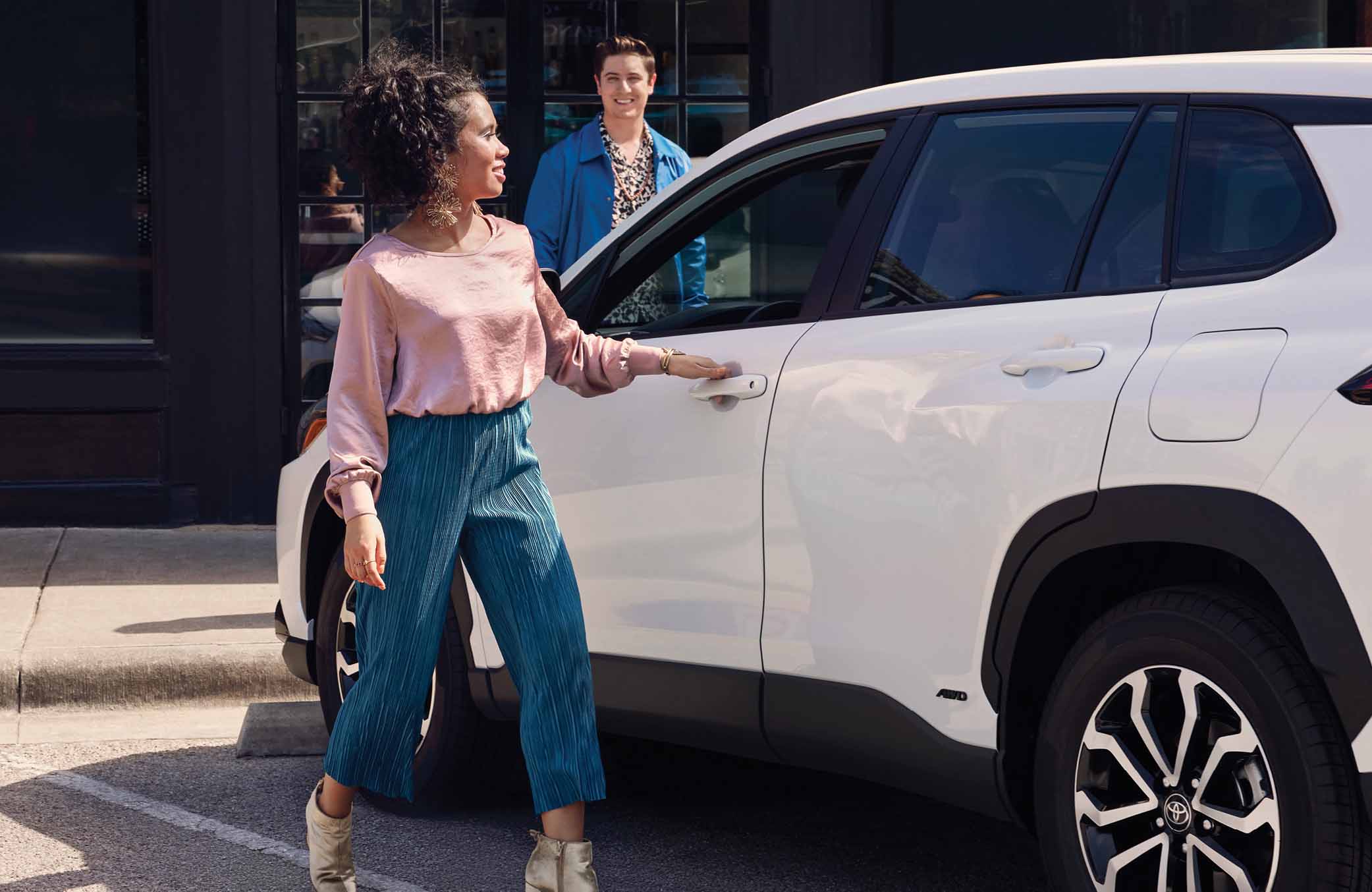 Woman entering New Toyota vehicle from the driver side