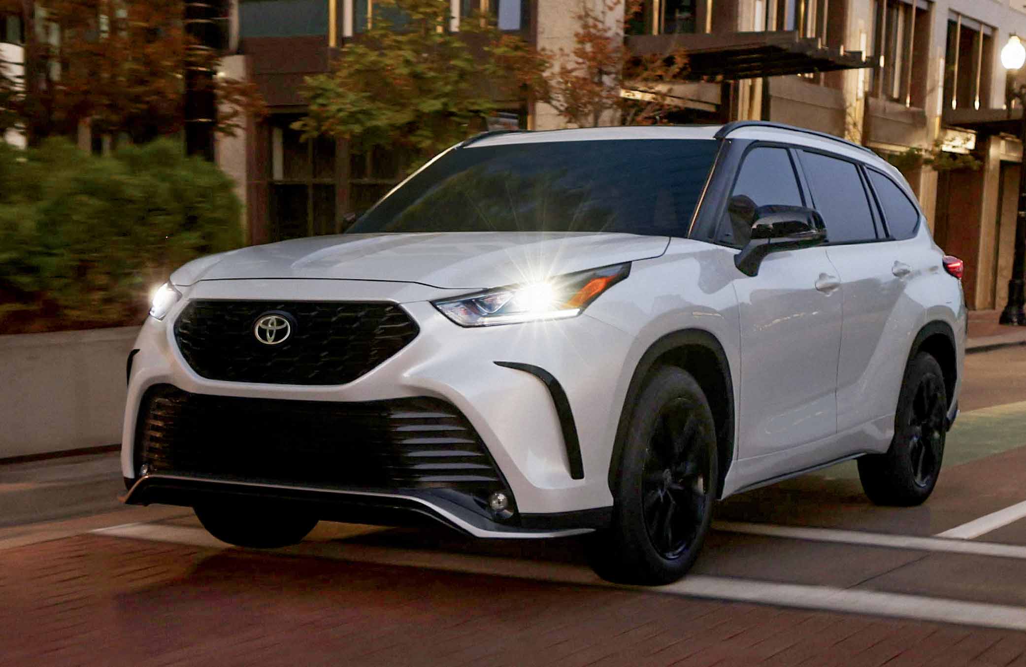 New 2023 Toyota Highlander driving making a corner